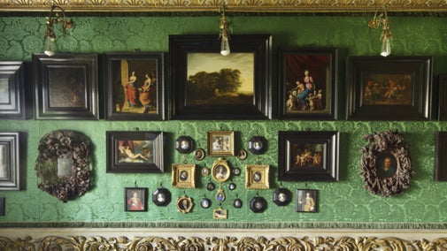 Pictures and miniatures hang in the Green Closet at Ham House, London